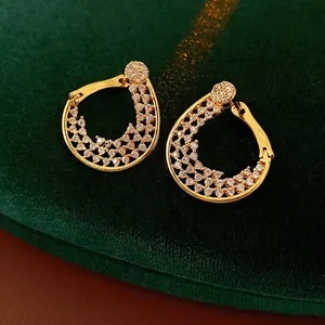 Exquisite gold-plated teardrop hoop earrings with pavé cubic zirconia on velvet