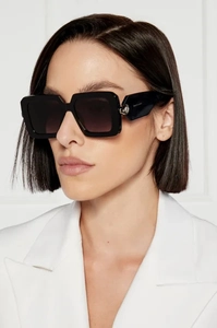 Close-up of thick black square sunglasses frame with silver metal logo on the temple