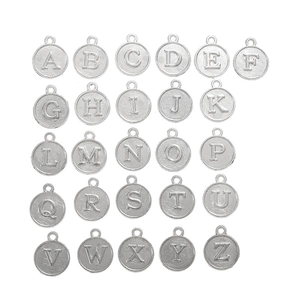 Set of 26 silver alloy alphabet charms for DIY jewelry making neatly arranged