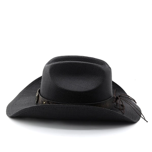 Close-up of woven straw cowboy hat featuring a vintage brown band and rustic knot detail