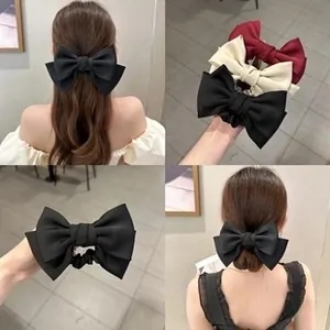 Detail of double-layered chiffon bow hair ties in black, cream, and wine red colors