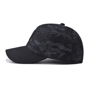 Side view of camouflage baseball cap featuring a circular metal logo and durable fabric