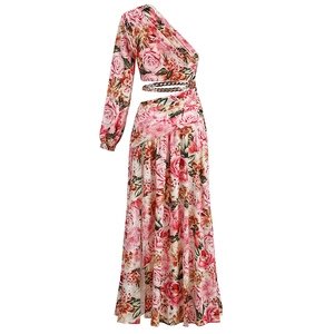 Detail of floral one-shoulder dress with waist cutout and gold chain link detail