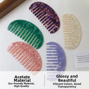 Detail of five portable acetate wide-tooth hair combs in various floral and pastel colors