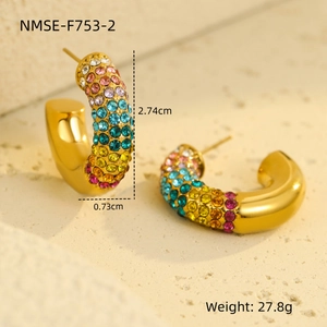 Detailed macro view of 18K gold C-shaped earrings with colorful rainbow cubic zirconia