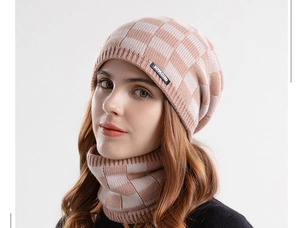 Detail of pink and white checkered knit beanie and scarf set with soft warm fleece lining