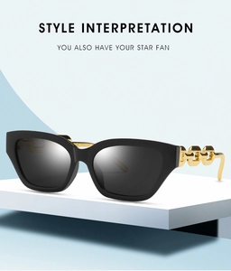 Detailed view of narrow cat-eye sunglasses with golden hollow chain metal temples