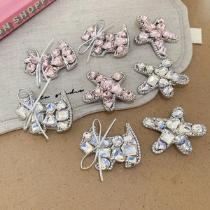 Detail showing crystal-studded star and dog-shaped hair clips with silver bow accents