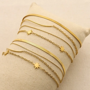 Layered 18K gold plated stainless steel bracelet with sunburst charm and snake chain