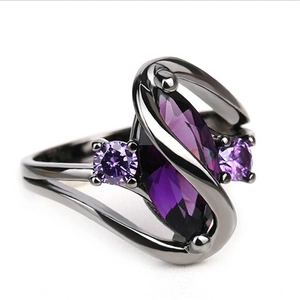 Macro shot of gun-black plated ring featuring marquise-cut purple zircon in twist design