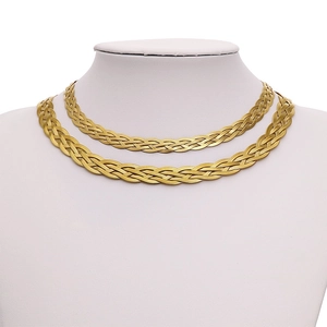 Layered gold woven herringbone snake chain necklaces on a white mannequin bust display