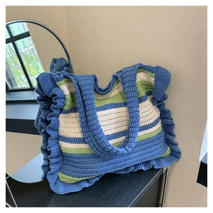 Detail of colorful striped crochet tote bag with ruffles and handmade knit texture