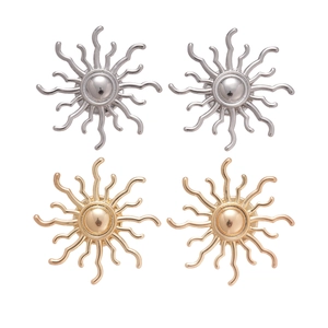 Minimalist metal sunflower stud earrings in gold and silver finishes on a white background