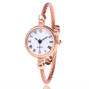 Elegant rose gold bangle watch with twisted rope metal strap and Roman numeral dial