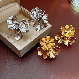 Elegant gold and silver floral statement rings with hollowed petal design on luxury display