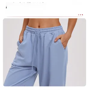 Close-up of drawstring elastic waistband and side pocket on light blue sports trousers