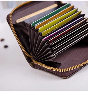 Detail view of coffee-colored accordion card slots with gold zipper and retro pattern