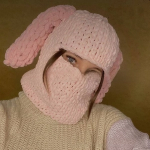 Detailed knit texture of pink Balaclava hat with long rabbit ears for winter warmth