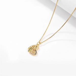 Close-up of golden MOM heart pendant with colorful zircon stones on a box chain