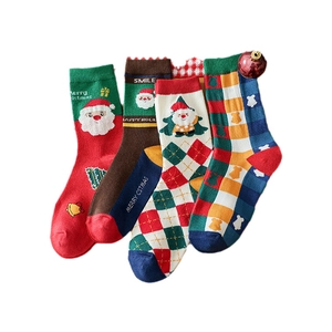 Set of 4 Christmas mid-calf socks with festive patterns like Santa and trees in a gift box