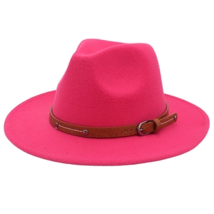 Detail of fuchsia wool fedora hat featuring a brown leather band with silver metal studs