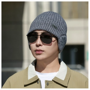 Detail of dark grey ribbed knit beanie with ear flaps and FBHS label for winter warmth