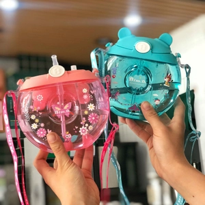 Close-up of pink and blue donut-shaped kids straw cups with bear ear lids and straps