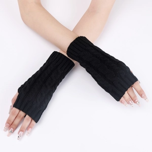Detail of cable knit pattern on black fingerless arm warmers worn on crossed arms