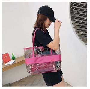 Transparent PVC tote bag with pink straps shown by a model for a stylish summer look
