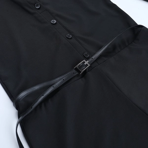 Detail of V-neck jumpsuit featuring waist belt with silver buckle and resin buttons