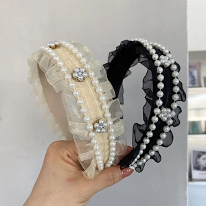 Close-up of pleated tulle headband with faux pearls in cream white and classic black
