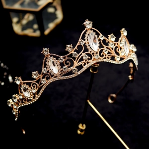 Macro view of crystal crown with marquise-cut rhinestones and intricate gold metalwork