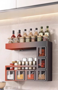 Detail of wall-mounted kitchen spice rack with multi-layer storage and clear drawers