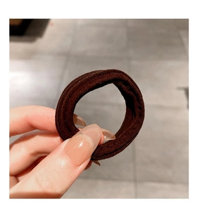 Close-up of a high-elasticity dark brown hair tie showing durable knitted texture