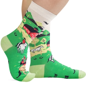 Detail of green mid-calf cotton socks with rural farm horse and barn knit patterns