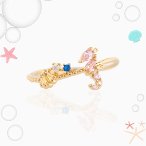 Golden ocean theme ring featuring seahorse and shell motifs with colorful cubic zirconia