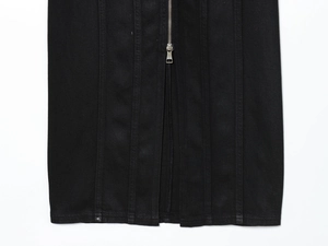 Detailed view of black denim dress showing silver metal zipper and twill fabric texture