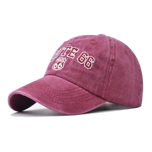 Detail of embroidered Route 66 logo on a vintage washed burgundy cotton baseball cap