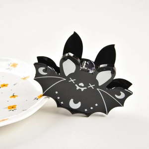 Detail of bat-shaped hair claw clip with lunar accents for Halloween gothic styling