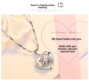Macro detail of silver heart necklace with sparkling center crystal and twisted chain