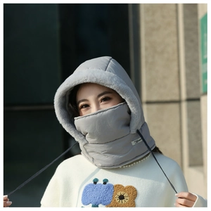 Close-up view of a grey winter windproof hat with integrated fleece mask worn by a model