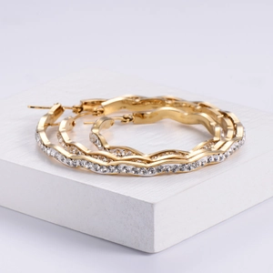 Elegant gold plated wavy hoop earrings for women featuring sparkling cubic zirconia studs