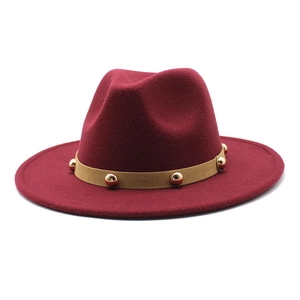 Detail view of burgundy wool fedora with khaki suede band and gold metal studs