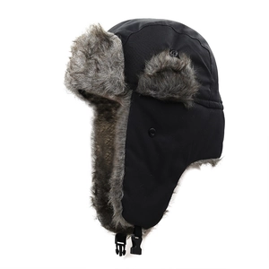 Detail of winter trapper hat with black windproof fabric and thick grey faux fur lining