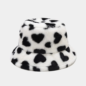 Close-up of fluffy black and white heart pattern plush bucket hat texture detail