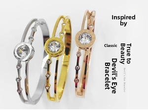 Detailed view of triple rose gold hollow bracelets with Roman numerals and crystals