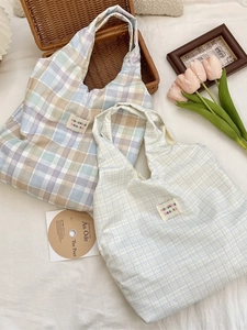 Checkered canvas shoulder bag in pastel tones with integrated handle and brand label
