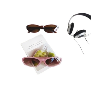 Vintage oval cat-eye sunglasses in brown tortoise and pink frames on white background