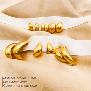 Titanium steel stud earrings in 14K gold finish with size markers on silk background
