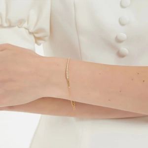 Close-up of gold S925 sterling silver bracelet featuring sparkling white zircon stones